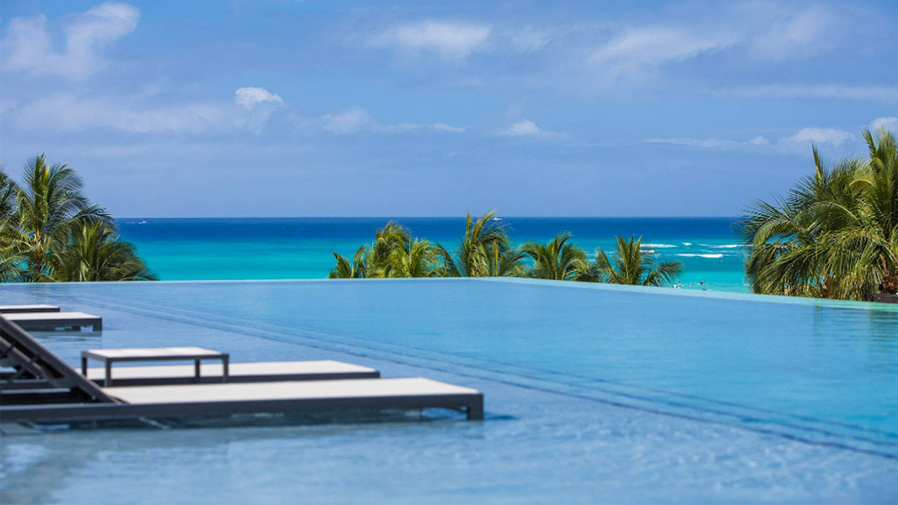 Alohilani Resort’s Grand Opening Celebration package provides VIP access to infinity pool loungers overlooking Waikiki Beach.