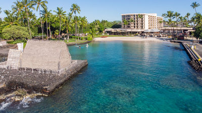 The hotel overlooks peaceful Kamakahonu Bay and the reconstructed Ahuena Heiau temple.