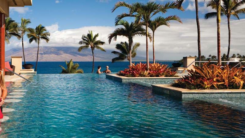 With cabanas, a swim-up bar and an underwater music system, the Serenity pool is a favorite destination at the Four Seasons Resort Maui. // © 2014 Four Seasons Resort Maui F
