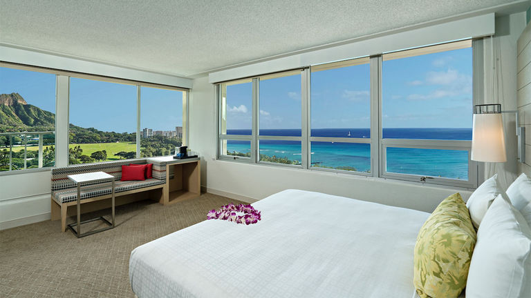 Large windows showcase the surroundings in Queen Kapiolani’s updated guestrooms.