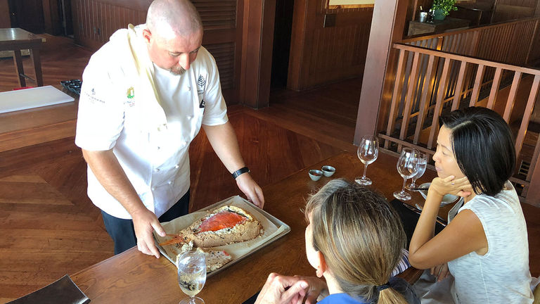 Four Seasons Chef Thomas Bellec presents participants with a salt-encrusted fish during the cooking class.