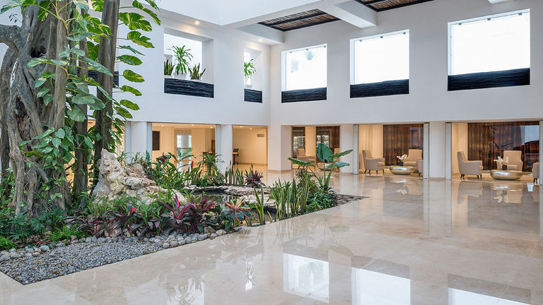 The lobby combines nature with upscale comfort.