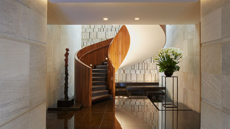 The central staircase is a jaw-dropping visual, showcasing the property’s design-forward approach.