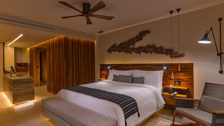 Guestrooms feature wood decor and warm tones.