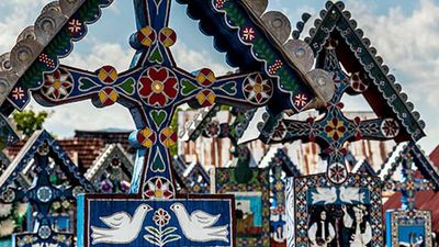 Most of the headstones at Merry Cemetery were carved by hand and painted by the same man for 40 years. // © 2017 Creative Commons user Marian Gabriel Constantin