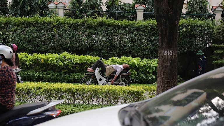 A man rests on his bike in the afternoon in HCMC, a metropolis of 12 million people.
