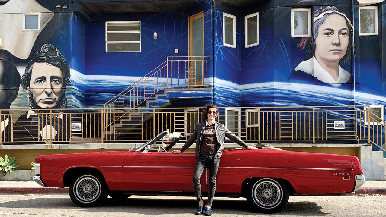 The writer's ToursByLocals guide poses at the Luminaries of Pantheism mural in Venice, Calif.