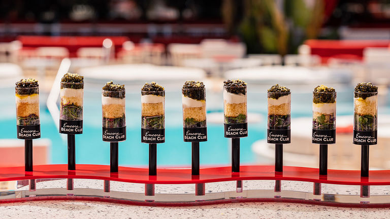 VIP guests snack on caviar push pops at Encore Beach Club.