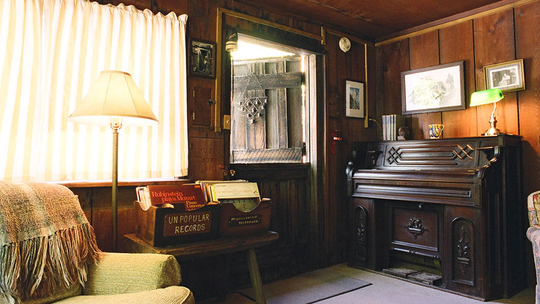 Grandpa’s Room features a queen bed, a single bed in an alcove, a piano, a wood-burning stove and a record player.