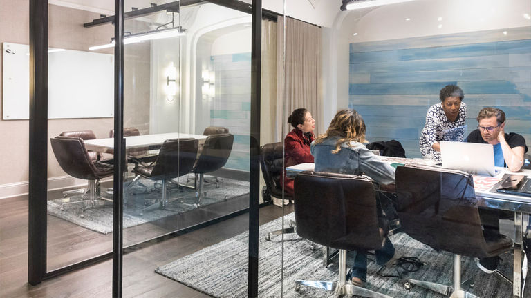 The lobby features glass-enclosed offices.