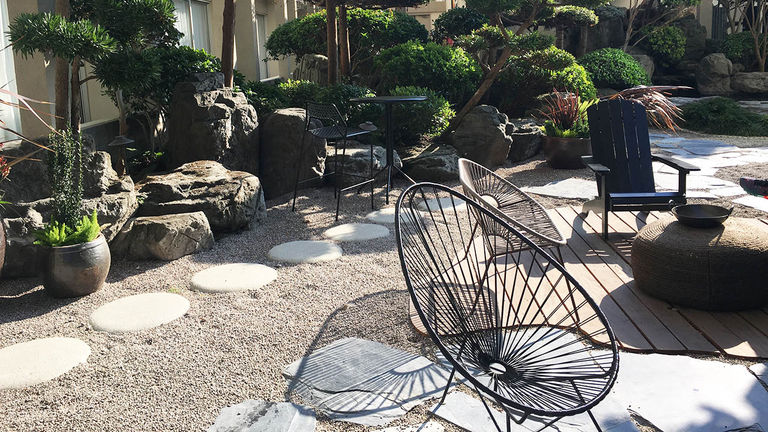 The Haven, an enclosed outdoor space, features seating areas, a firepit, a koi pond and more.