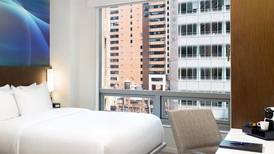 Oversize windows and bold colors add light and cheer to Luma’s guest rooms. // © 2017 Luma Hotel Times Square