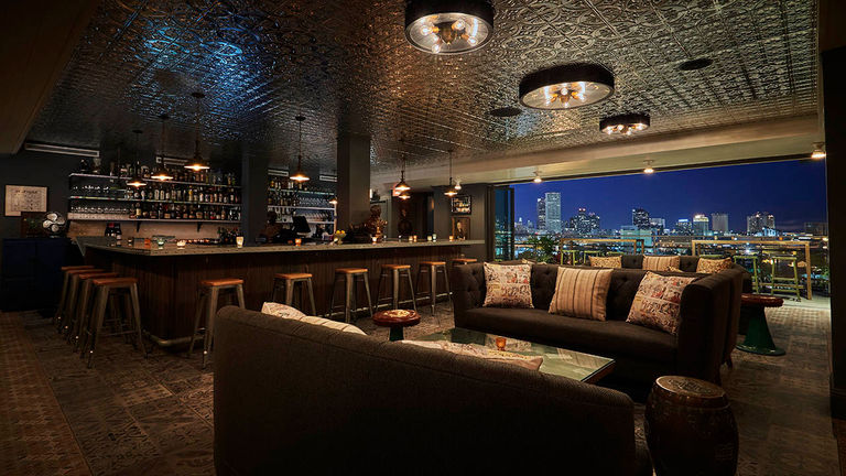 Trendy rooftop bar Hot Tin offers excellent views of downtown New Orleans and the Mississippi River.