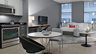 Q&A's fully-furnished rooms feature decidedly modern decor. // © 2016 Q&A Residential Hotel