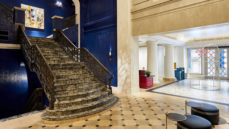 The lobby features a grand staircase and a 12-foot-high bird cage that is a tribute to Dashiell Hammett’s “The Maltese Falcon.”
