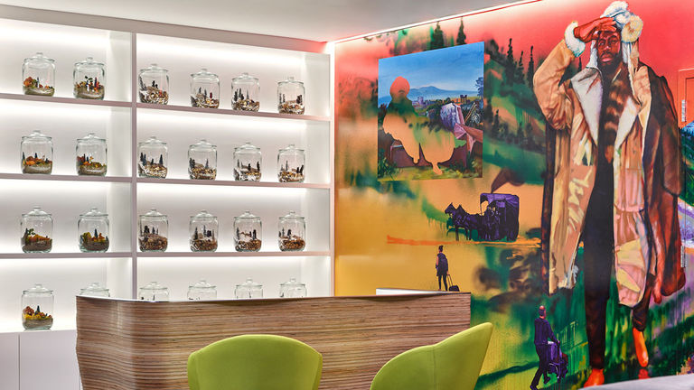 The lobby features a colorful mural by artist Gaia that paints a youthful and modern take on local culture.