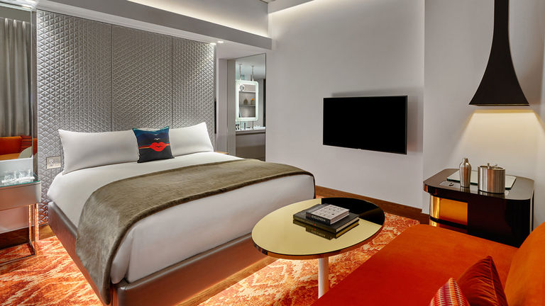 A Fabulous king guestroom features pops of color and bed pillow graphics inspired by famed Aspen artist Herbert Bayer.