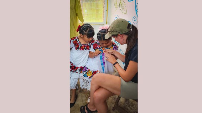 The author learning how to stich at the Lol-Chuy artisan cooperative in X-Pichil, Mexico The author learning how to stich at the Lol-Chuy artisan cooperative in X-Pichil, Mexico