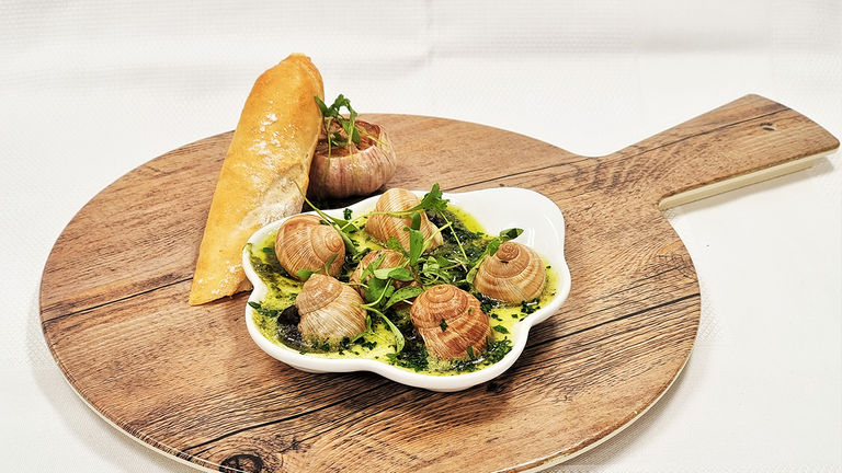 Cruisers can order escargot at Rudi’s Sel de Mer onboard Holland America Line