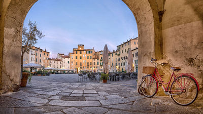 When visiting Tuscany with kids, try adding active elements to sightseeing, like biking through a town square.