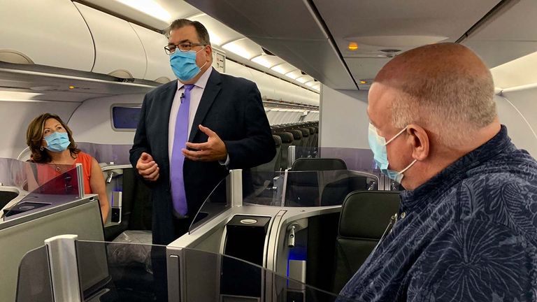 Travel industry executives are briefed by Jason Annunziata, director of JetBlue, at Fort Lauderdale-Hollywood International Airport onboard a JetBlue A321 Mint aircraft about the airlines’ air filtration and cleaning procedures to avoid the spread of COVID-19.