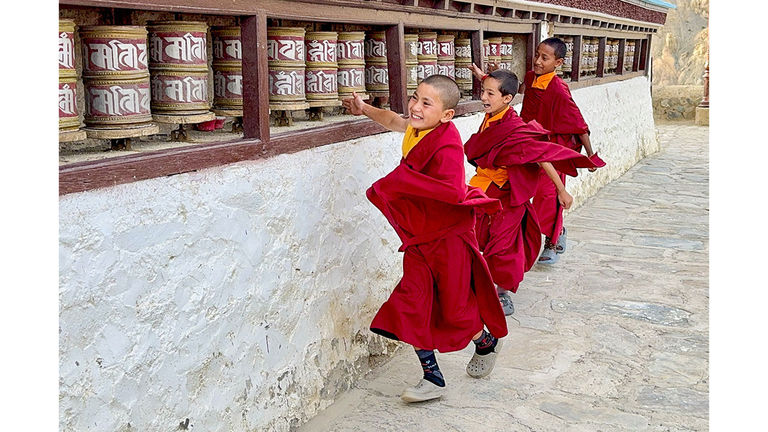 Young monks share a playful moment in Ladakh, India.