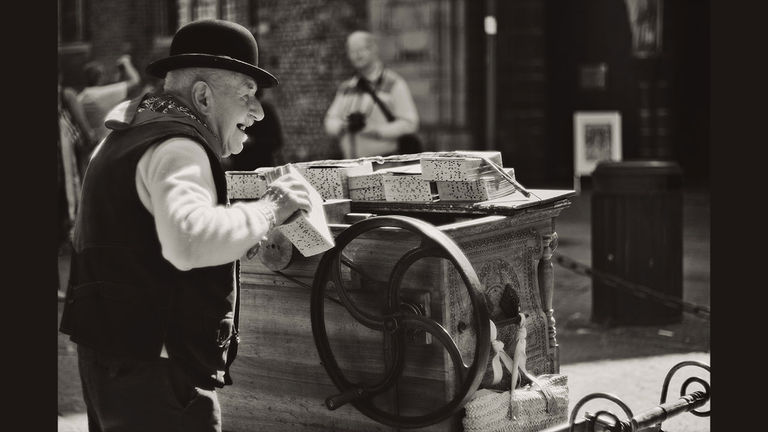 A musician playing the barrel organ in Bruges, Belgium