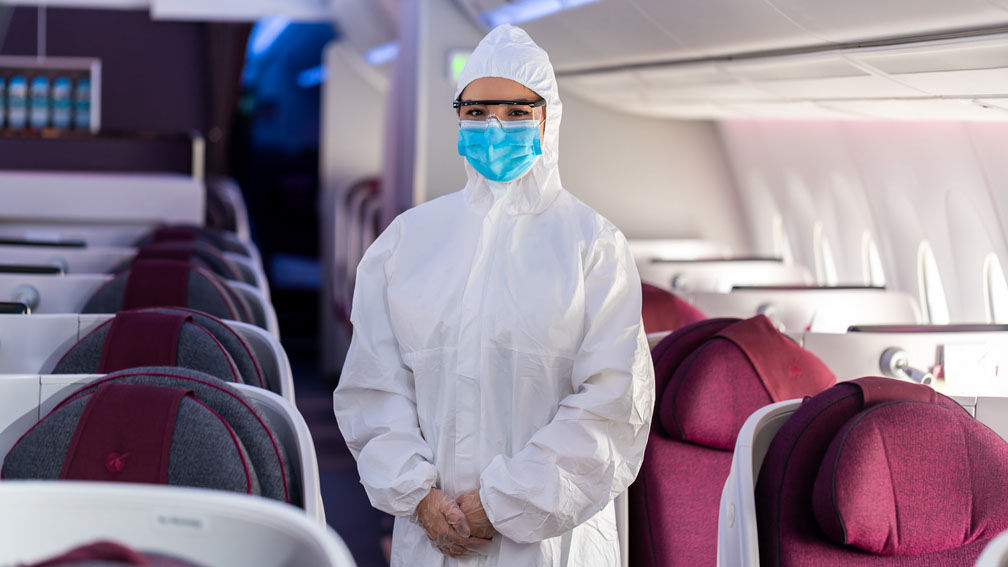 Qatar Airways crew wear full personal protective equipment on flights, which includes masks and gloves.