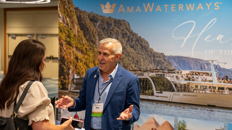 Alex Pinelo of AmaWaterways connects with an advisor during the tradeshow portion of the event
