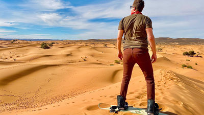 Try sandboarding while staying at Desert Luxury Camp in Morocco’s Sahara Desert.