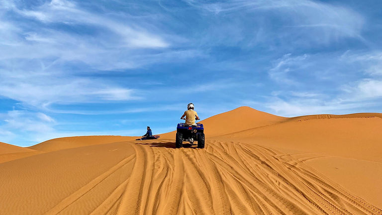 To ascend the highest dunes, ride an all-terrain vehicle through the desert.