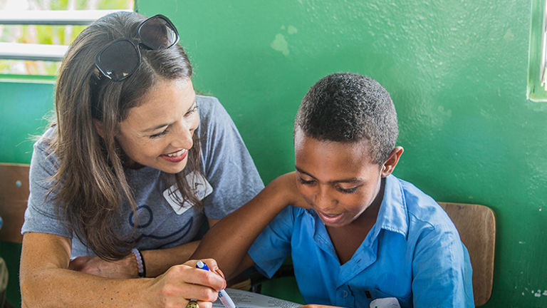 Fathom president Tara Russell participates in a fun activity promoting English proficiency. // © 2015 Fathom