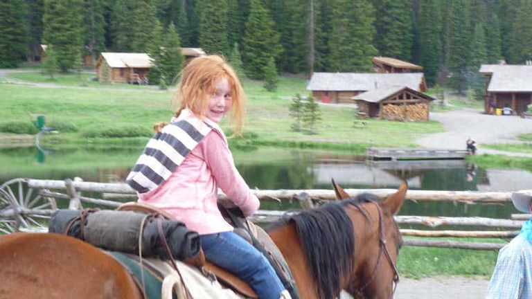Kids who are too young for the trail ride can still ride horses in the corral. // © 2013 Adventures by Disney