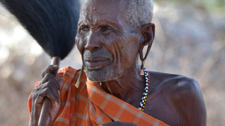 On an Abercrombie & Kent safari in Africa, a Samburu elder welcomes the tour group to his village. // © 2015 Africas Best Photos