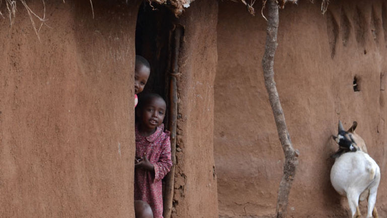 Maasai children peek out from their home. // © 2015 Africas Best Photos