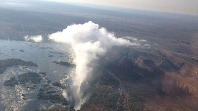 Visitors can take in an aerial view of Victoria Falls — a flourishing destination that straddles the border of both Zimbabwe and Zambia — by helicopter tour. // © 2014 Jimmy Im