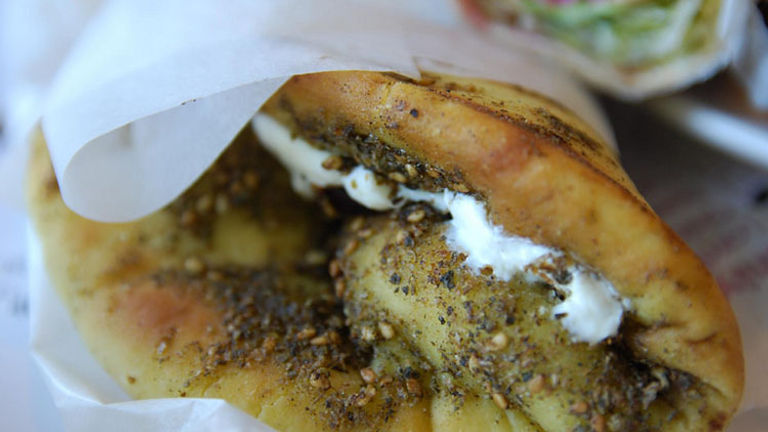 Manousheh is filled with zaatar and often a spoonful of labneh, which is similar to Greek yogurt. // © 2017 Creative Commons User avlxyz