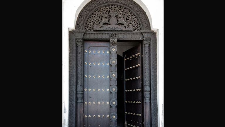 Elaborately carved wooden doors that have become the icons of Stone Town. // (c) 2013 Bob Demyan
