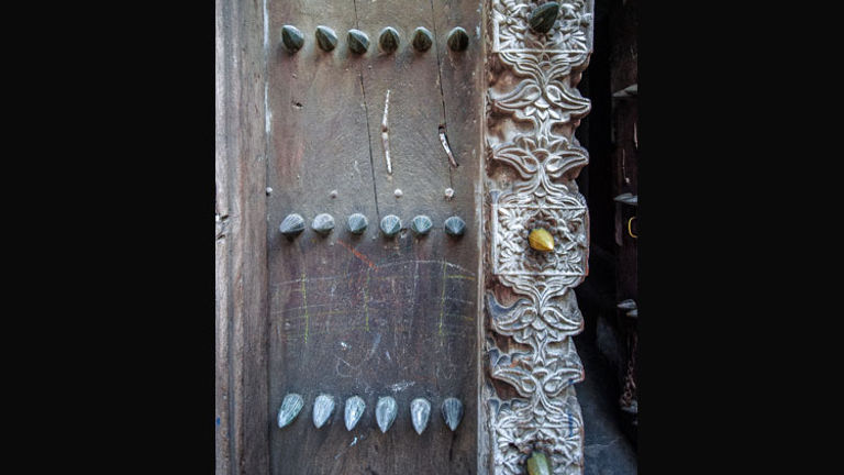 Large brass studs adorn many of Stone Town's doors. // (c) 2013 Bob Demyan