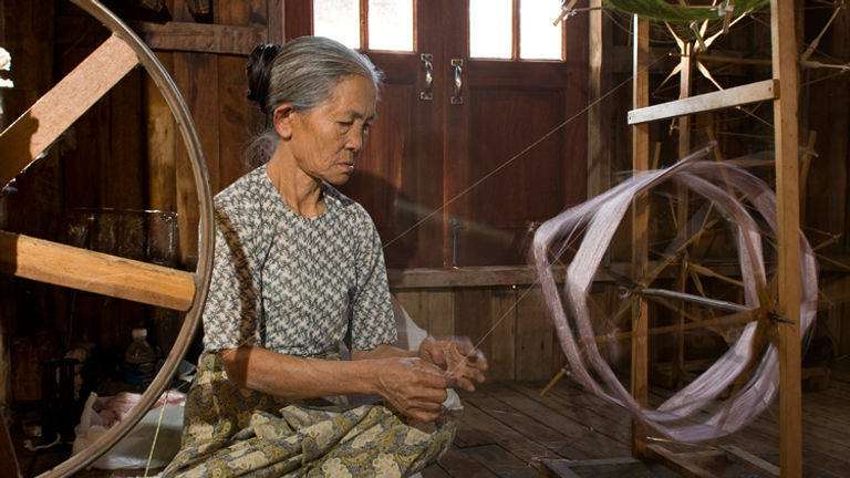 A woman creates fabric at a workshop built on stilts on Inle Lake. // © 2010 Mark Edward Harris