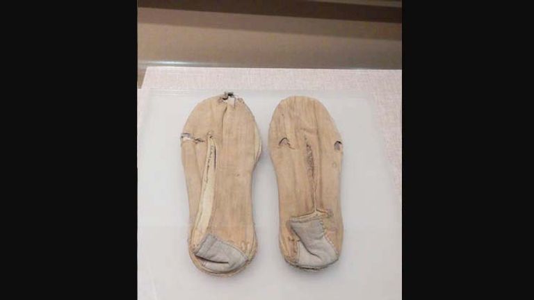 Museum visitors can view a range of Mao artifacts, including this pair of shoes he is said to have worn during a battle in Shaanxi. ‬// © 2014 Shane Nelson