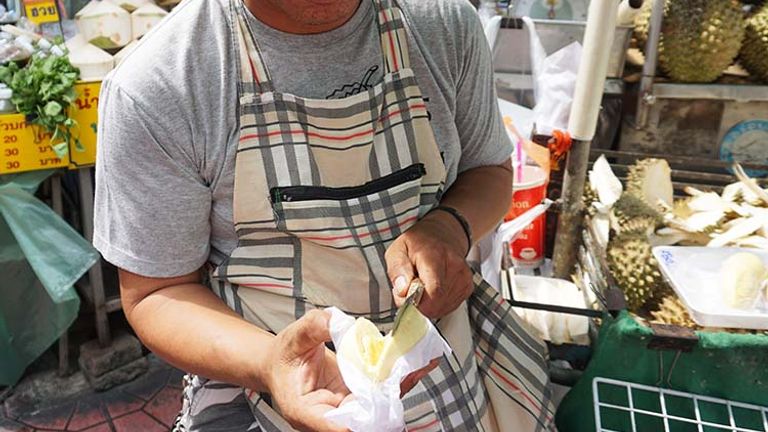 Cut open a durian to taste its creamy flesh, which many also find appetizing despite the fruit’s smell. // © 2017 Valerie Chen