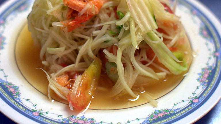 Shredded, unripe papaya is the star of the sour-yet-savory som tam, or green papaya salad. // © 2017 Creative Commons user scaredykat