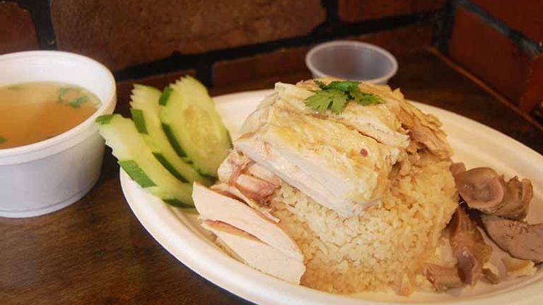 Khao man gai is a chicken-and-rice dish that is usually served with a light broth, cucumber slices, cilantro and a chili-ginger-garlic-soy sauce. // © 2017 Creative Commons user stuart_spivack