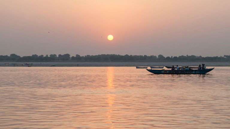 Experiencing Varanasi’s sunrise by boat on the Ganges River has become popular among tourists. // © 2014 Mindy Poder