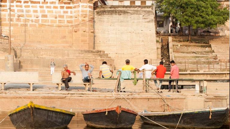 A group of men sit near the banks of the Ganges River in Varanasi // © 2014 Mindy Poder
