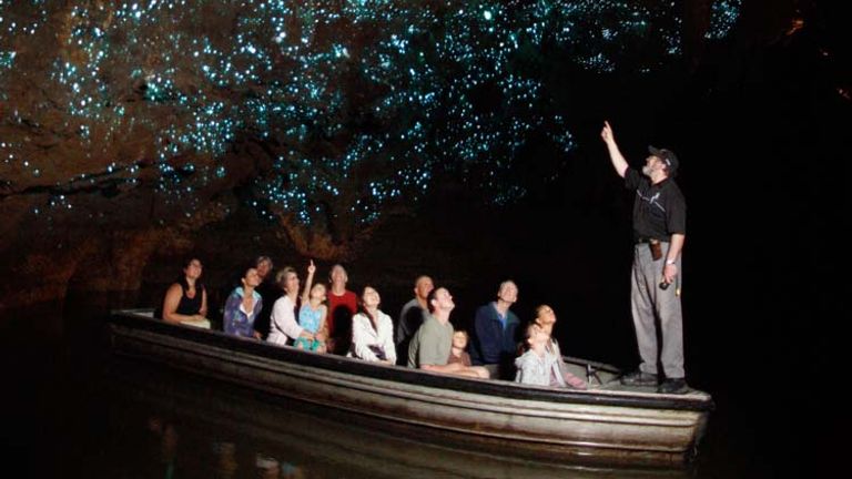The glowworms on the walls of Waitomo Caves create a surreal, star-like backdrop for visitors to this popular North Island destination. // © 2014 Waitomo Glowworm Caves
