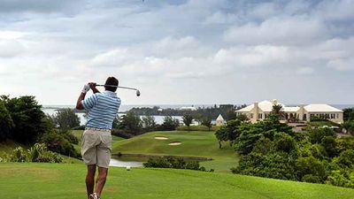 A golfer takes a swing at the 18th hole at Tucker’s Point Club, one of Bermuda’s best golf courses.  // © 2013 Mark Edward Harris