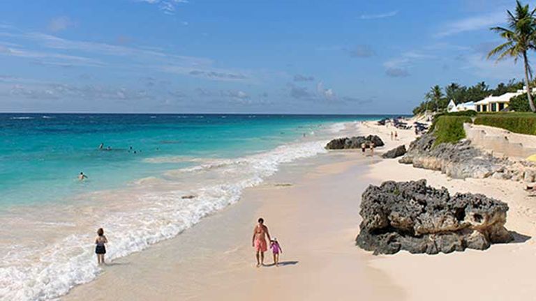 Tourists enjoy the light pink sands of Elbow Beach, Bermuda. // © 2013 Mark Edward Harris