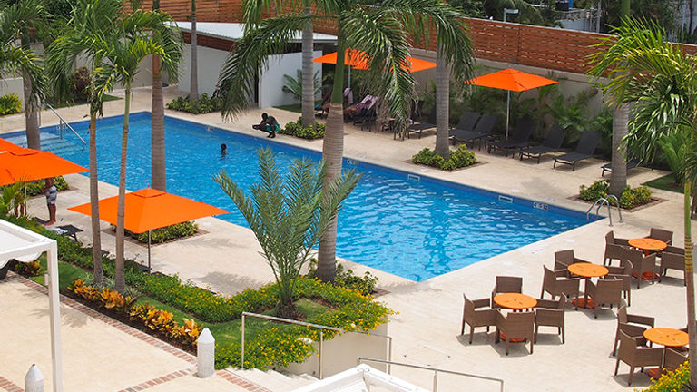 The hotel features amenities such as an outdoor pool and a fitness room with cardio equipment and weights. // © 2015 Zorianna Kit